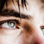 close up photo of gray-eyed man