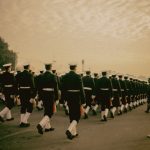 people in cadet uniform walking in line