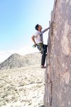 man climbing a mountain during daytime