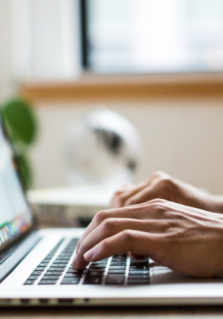 person typing on silver MacBook